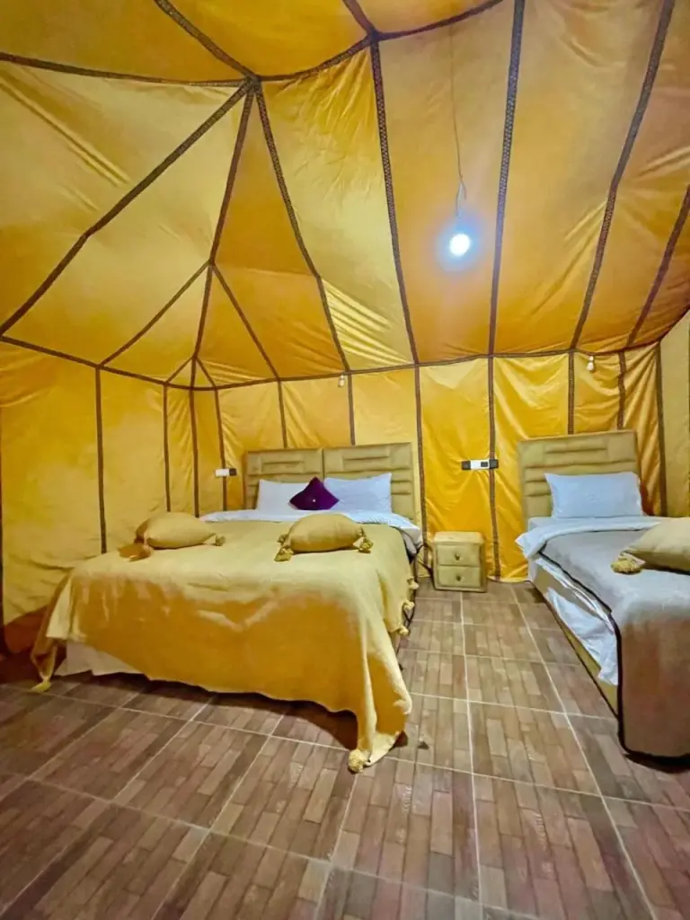 Double tent room at Merzouga Golden Dunes Luxury Camp in Merzouga with two beds and golden canvas walls.