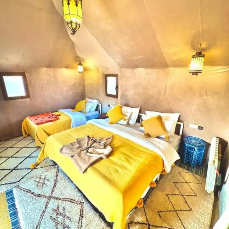 Merzouga Horizon Luxury Camp twin bed tent room with warm decor in Merzouga