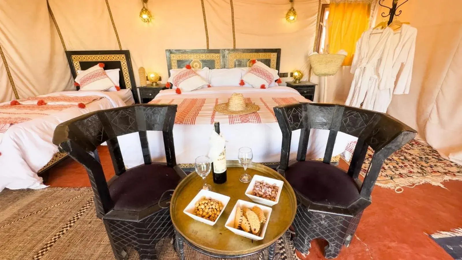 Luxury tent suite with twin and double beds at Merzouga Luxe Camp in Merzouga, Morocco