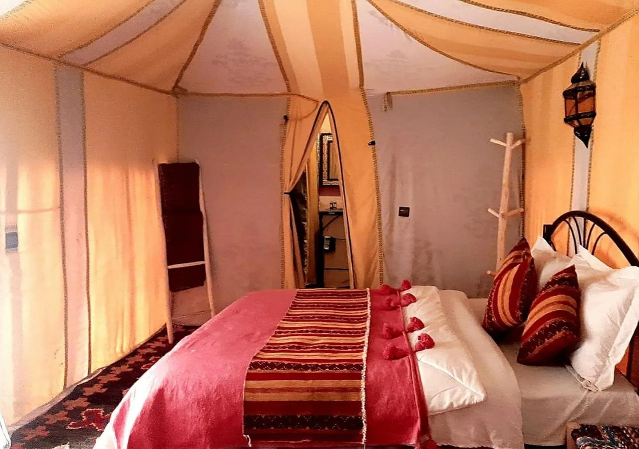 Cozy setup in a room at Merzouga Luxury Camp