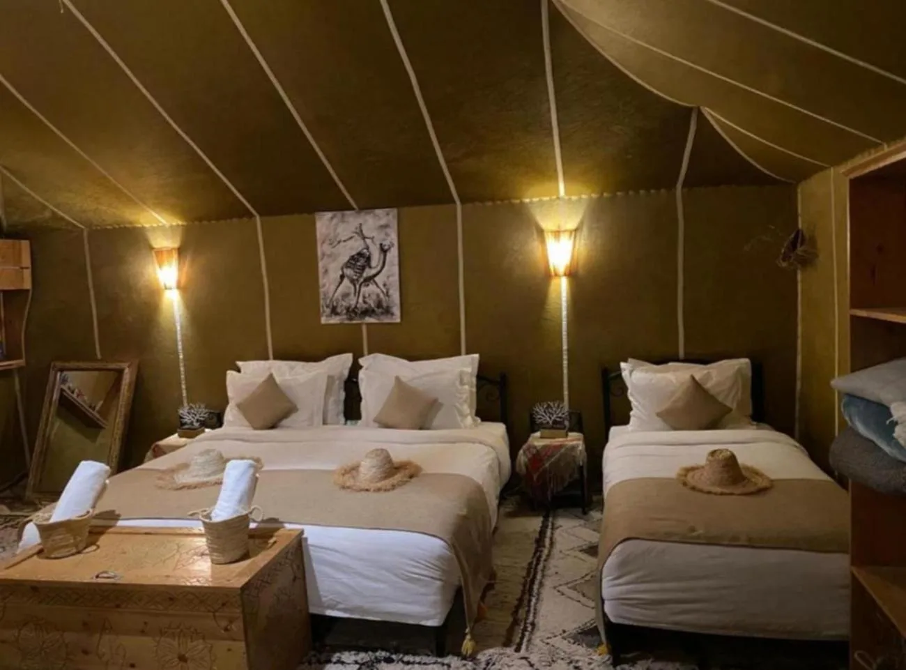 Twin bedroom interior at Merzouga Retreat Camp in Merzouga with two beds, lamps, and desert-style decor.