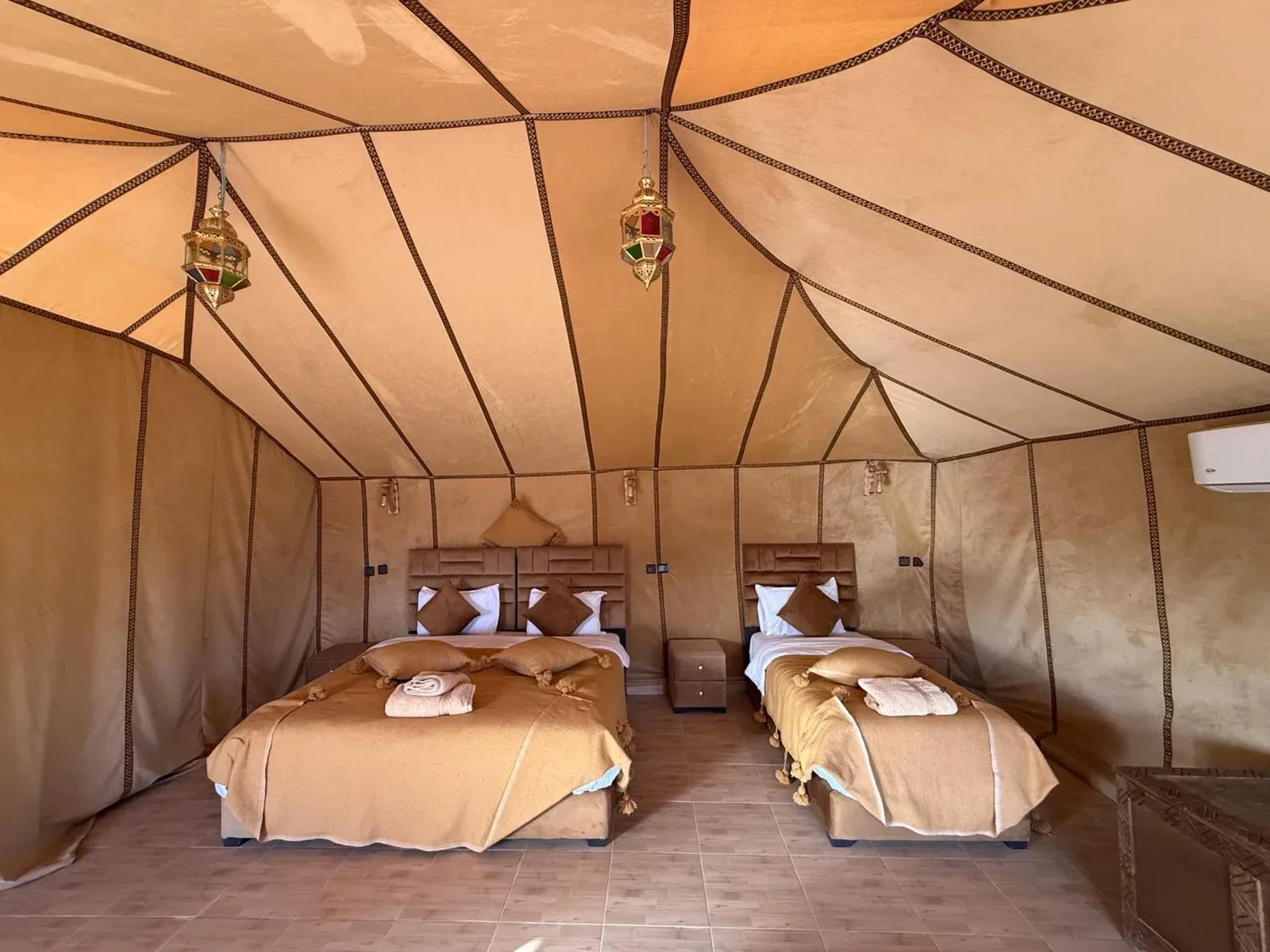 Milagro Luxury Camps in Merzouga twin tent room with two beds and warm desert-style decor