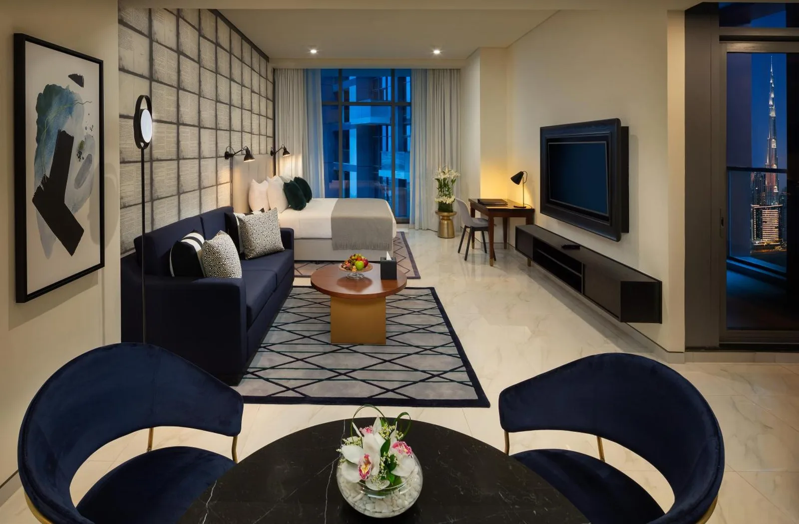 Millennium Atria Business Bay Dubai one bedroom suite with sofa, bed, and television