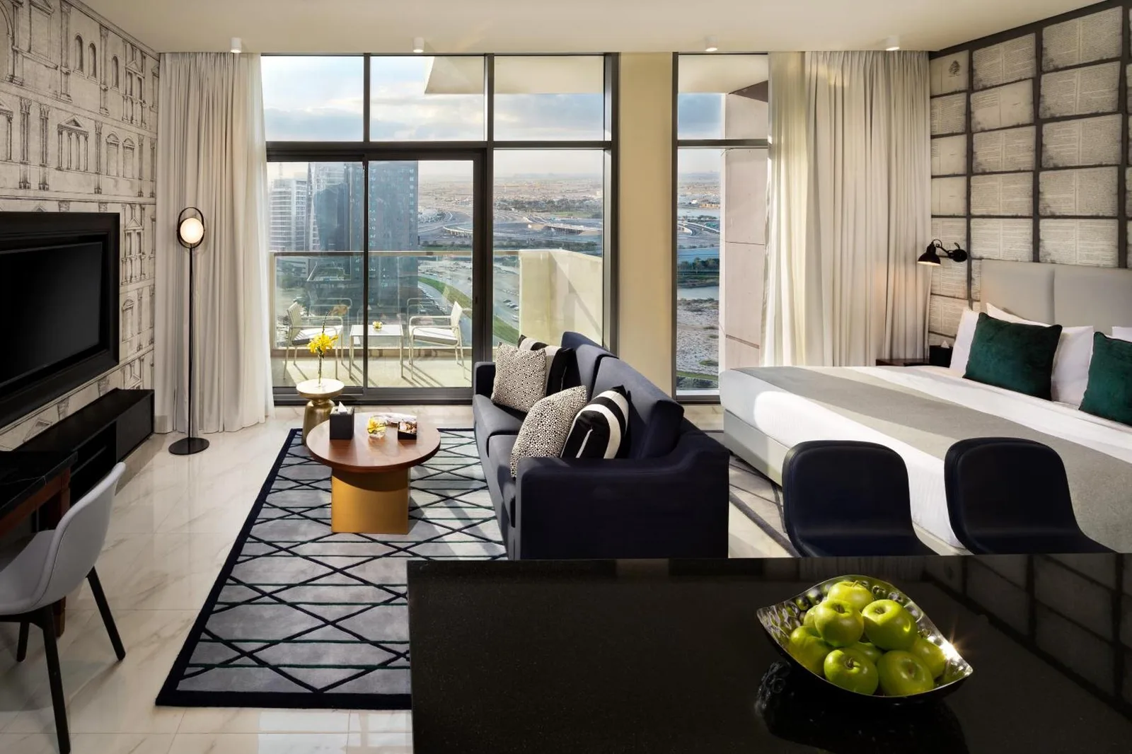 Millennium Atria Business Bay Dubai suite living area with sofa, balcony, and bedroom space