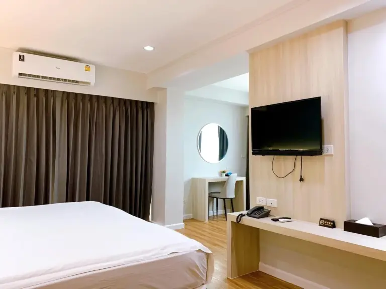 Bathroom at Miloft Sathorn Hotel in Bangkok with glass shower enclosure and toilet