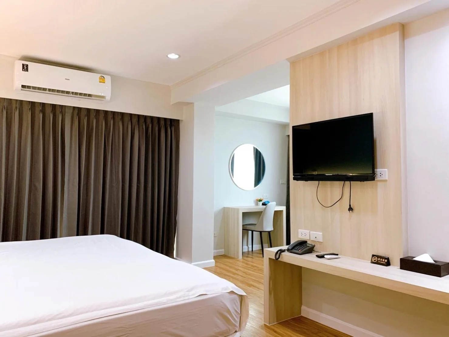 Bathroom at Miloft Sathorn Hotel in Bangkok with glass shower enclosure and toilet