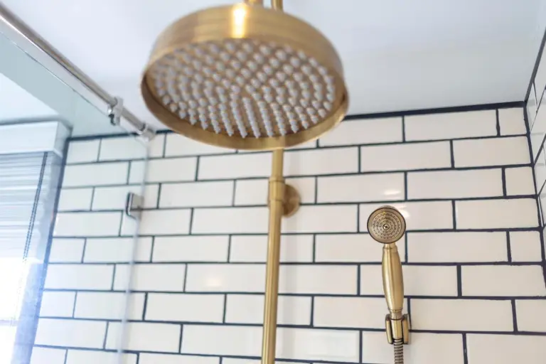 Gold rain shower at MORA Boutique Hotel Chiang Rai with white subway tile wall
