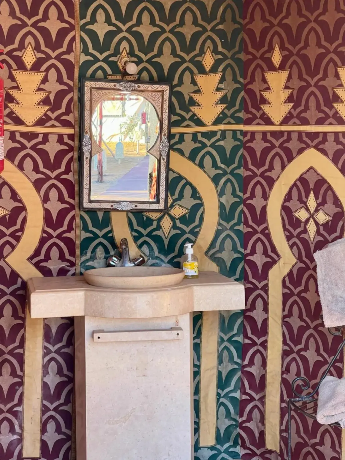 Moroccan Desert Camp in Merzouga bathroom sink area with decorative Moroccan wall design
