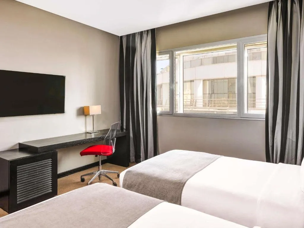 Mövenpick Hotel Casablanca – Casablanca, Morocco hotel – a hotel room with two beds and a desk at Mövenpick Hotel Casablanca in Casablanca