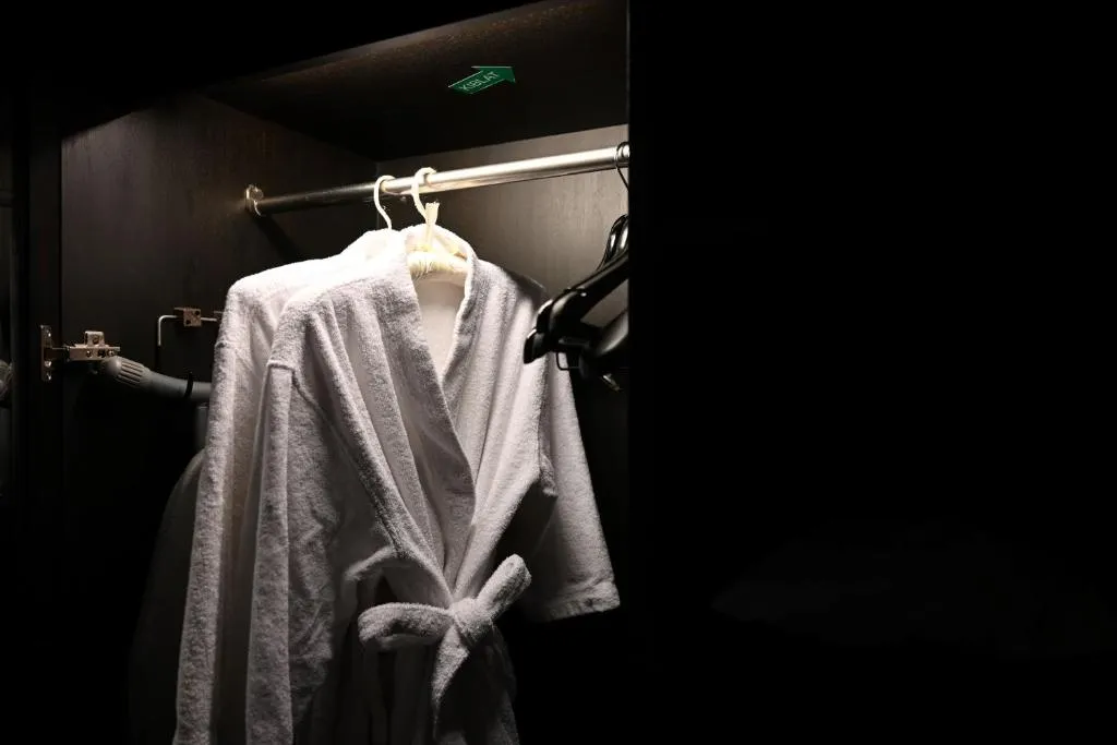 Bathrobes in wardrobe at Mövenpick Hotel Sukhumvit 15 Bangkok