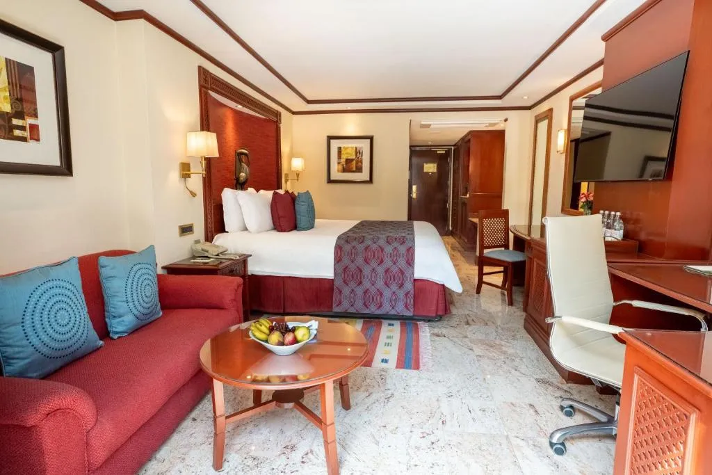 Guest room at Nairobi Serena Hotel with a comfortable sofa and modern amenities