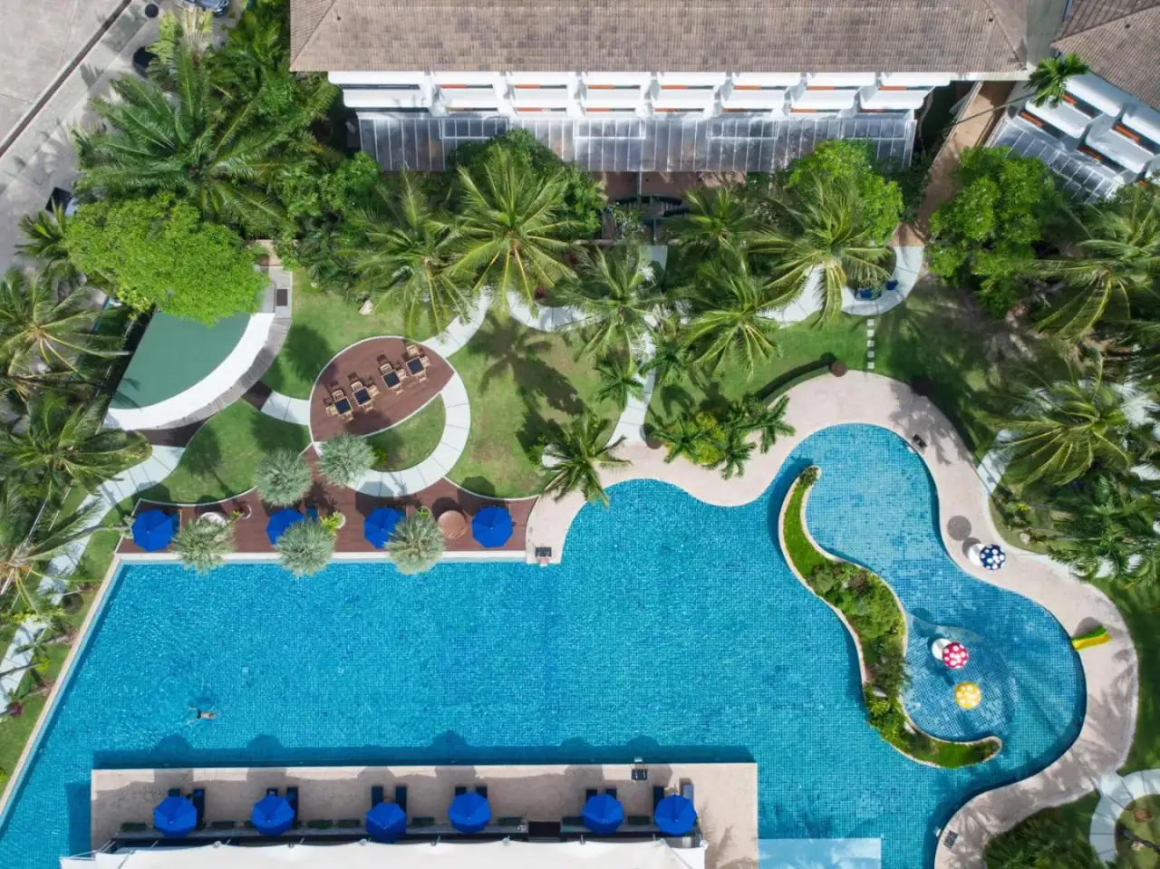 Aerial view of the swimming pool area at NH Boat Lagoon Phuket Resort in Phuket.
