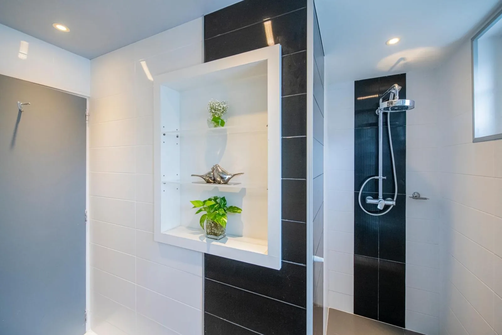 Walk-in shower and bathroom details at NH Boat Lagoon Phuket Resort in Phuket.