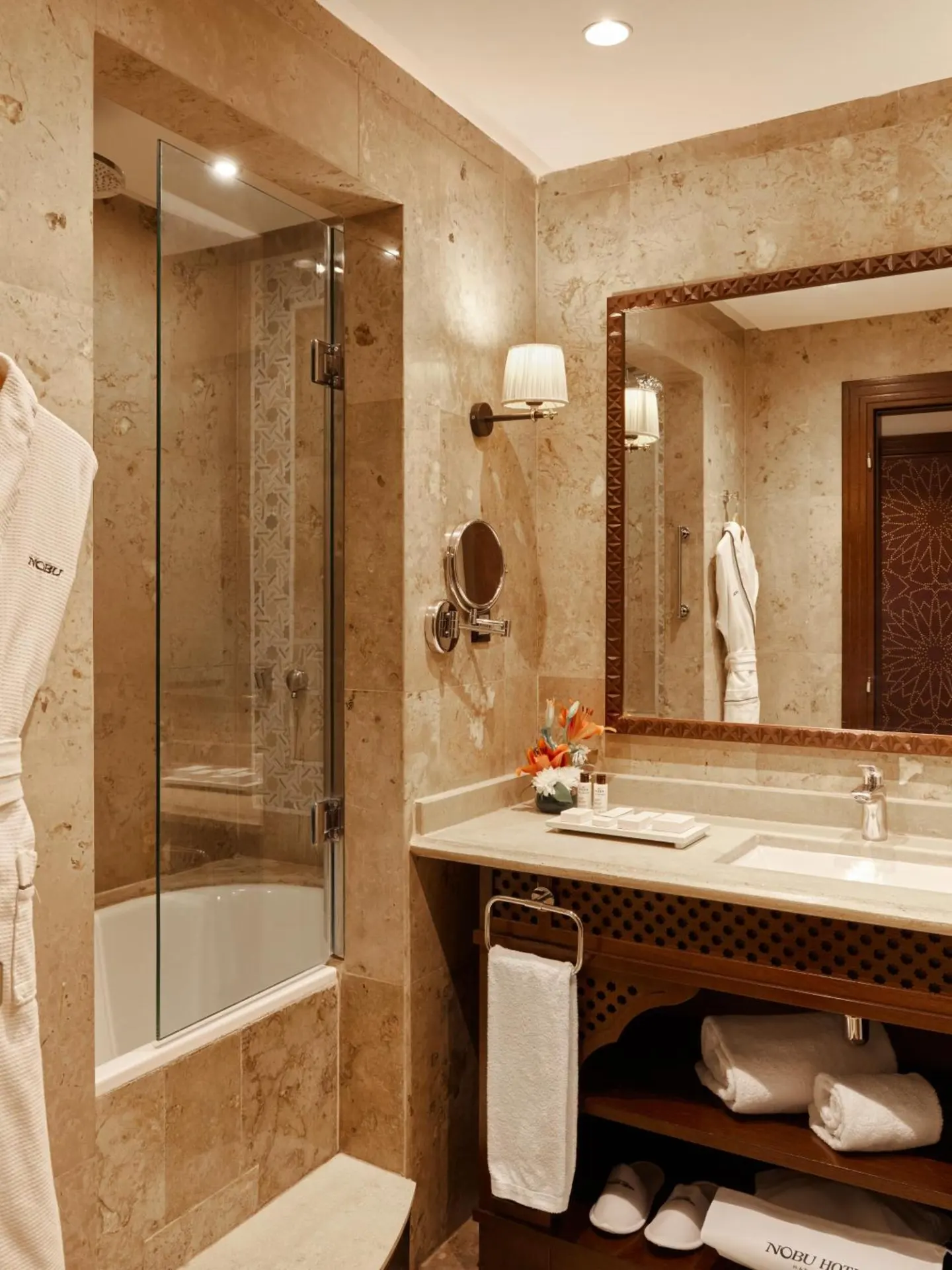 The modern bathroom in Nobu Hotel Marrakech featuring luxurious amenities.