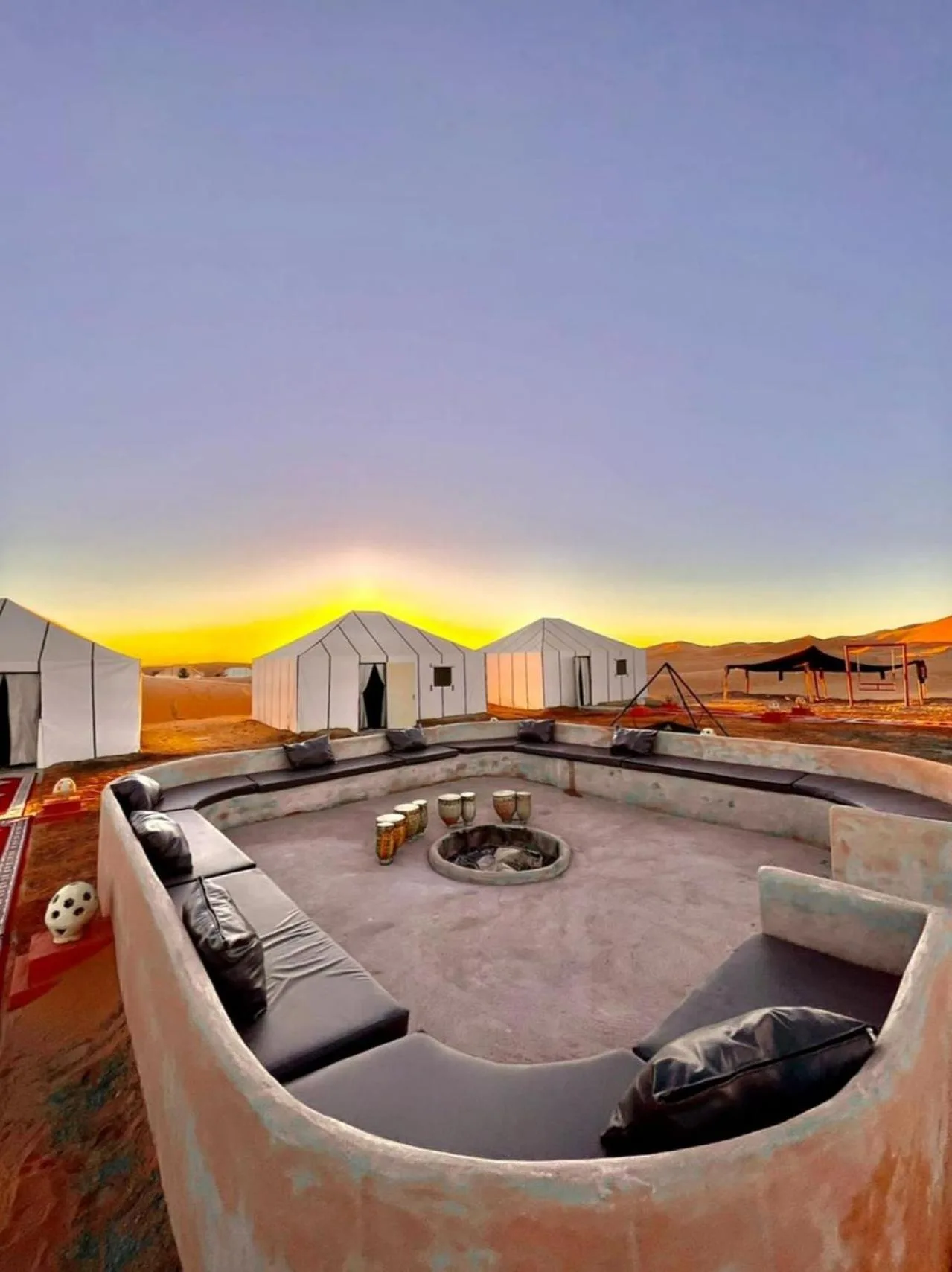 Espace salon à Nour Desert Luxury Camp au coucher du soleil