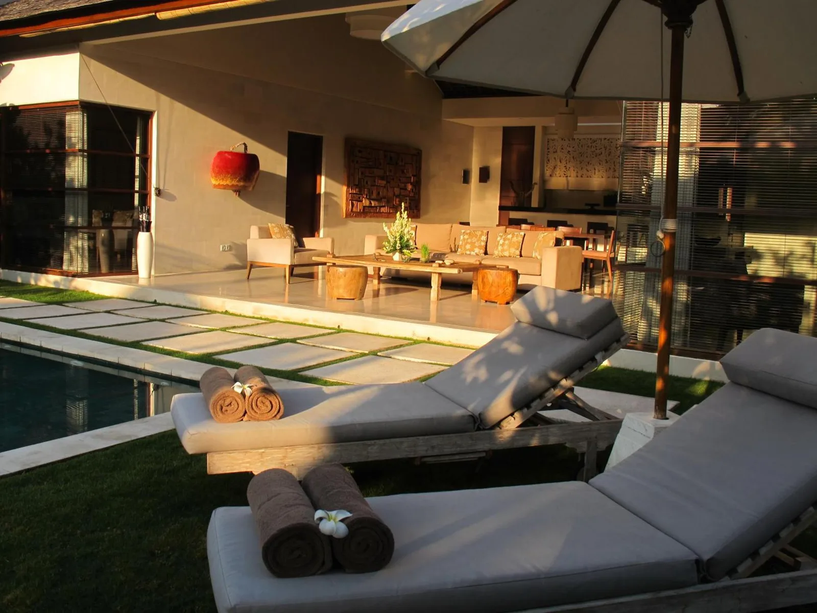 Comfortable lounge area by the pool at Nyaman Villas Seminyak