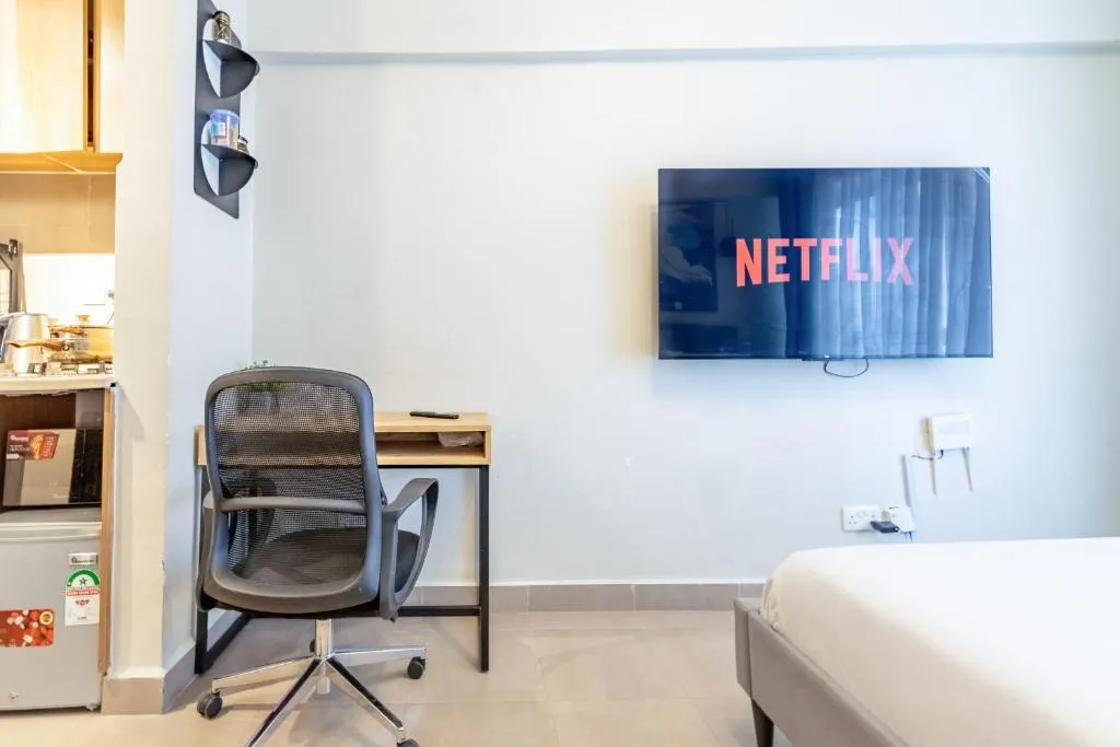 Living area with television at Nyayo Studio in Nairobi