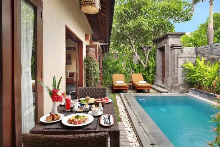 Breakfast served by the pool at Nyuh Bali Villas in Seminyak