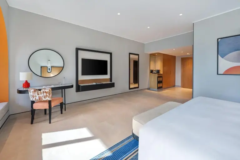 Open-plan hotel room layout at Oaks Ibn Battuta Gate Dubai with desk and TV area