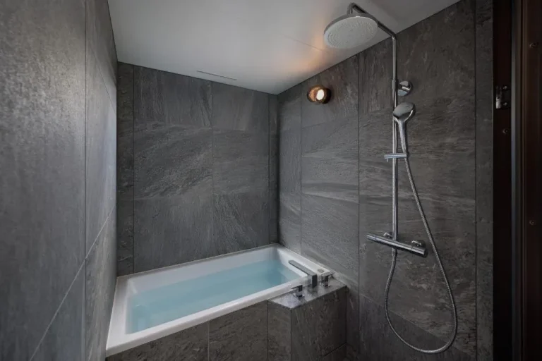 Shower and bathtub in bathroom at One Fukuoka Hotel