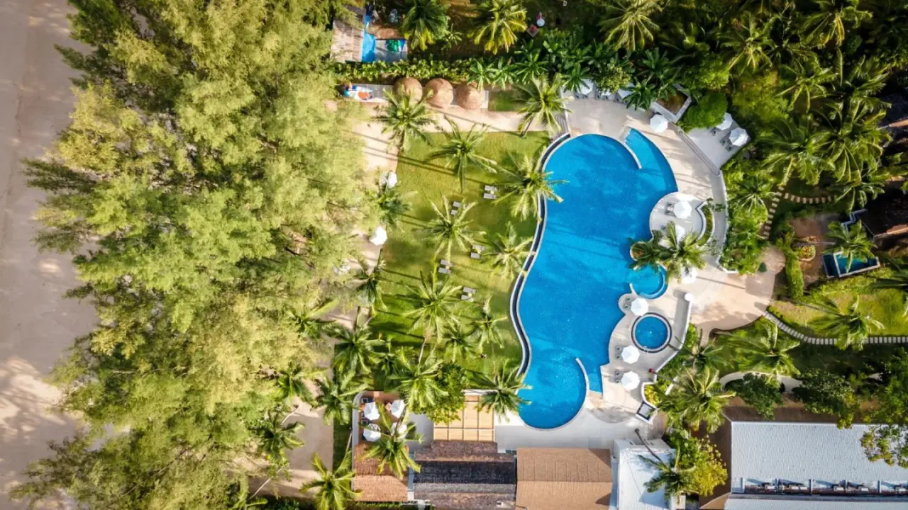 Aerial view of the pool area at OUTRIGGER Khao Lak Beach Resort in Khao Lak, Thailand