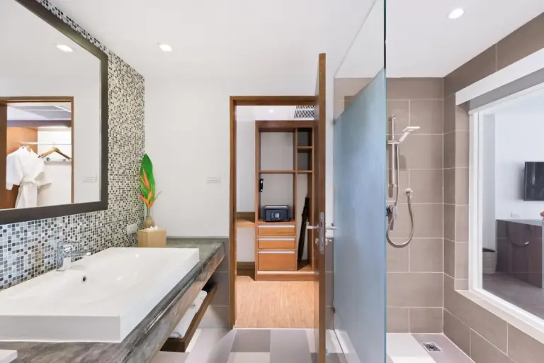Modern bathroom at OUTRIGGER Khao Lak Beach Resort in Khao Lak with shower and vanity