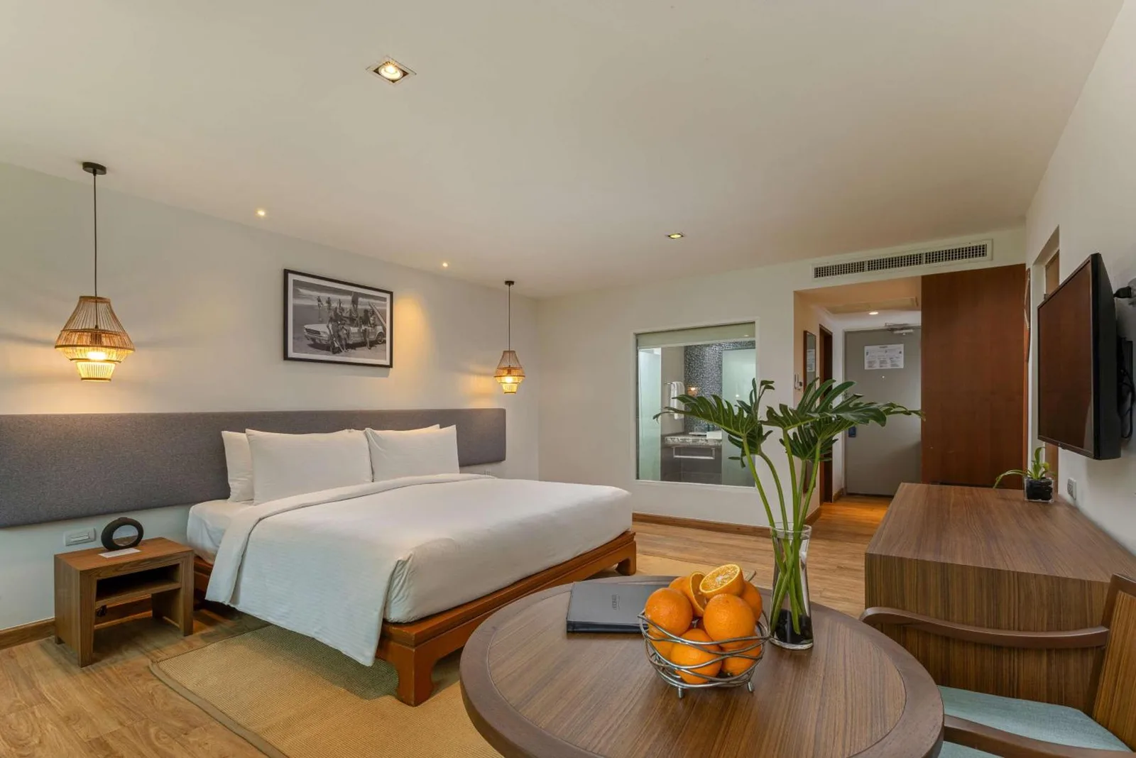 Spacious guest room at OUTRIGGER Khao Lak Beach Resort in Khao Lak with king bed and seating area