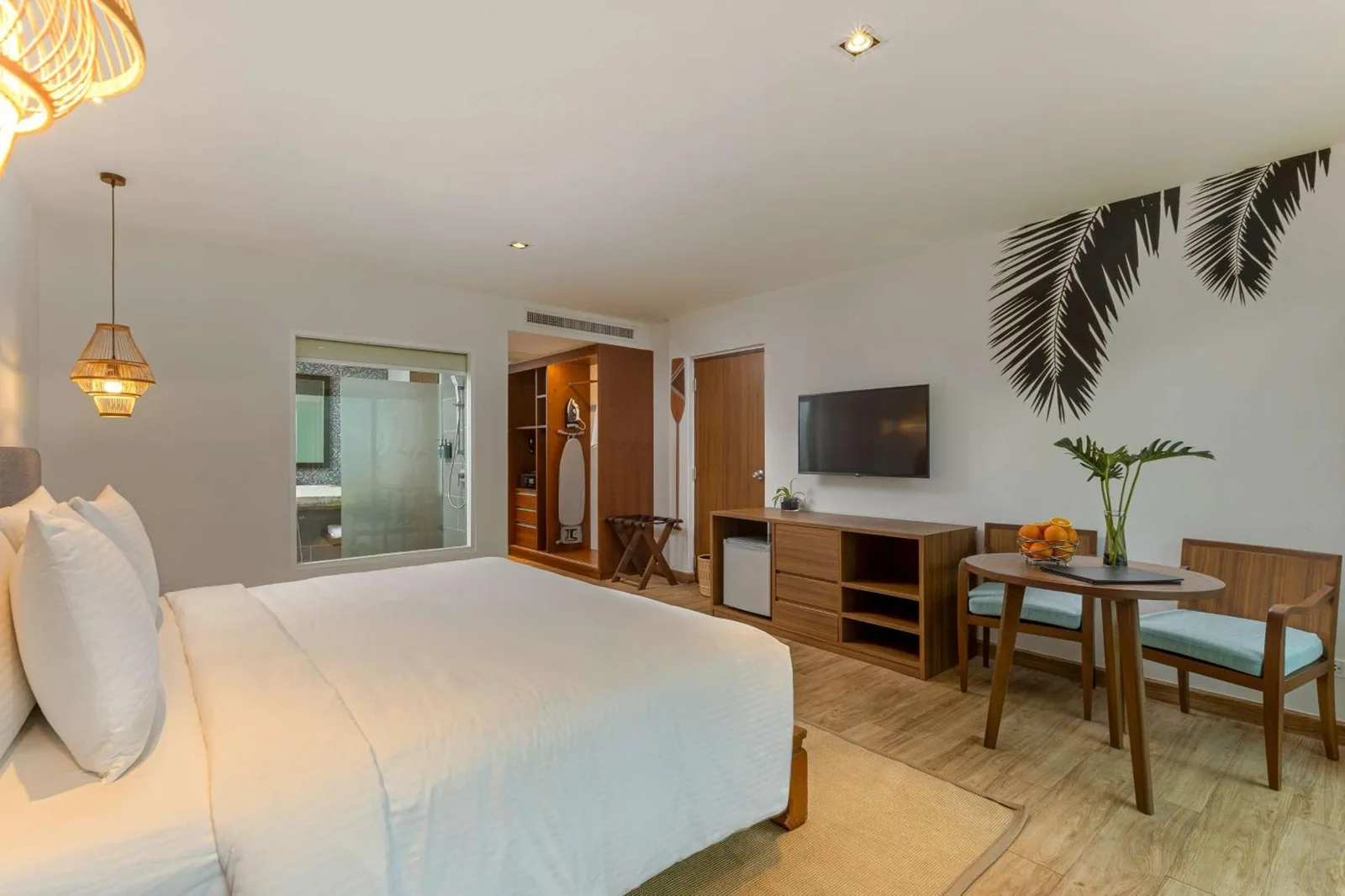 Guest room interior at OUTRIGGER Khao Lak Beach Resort in Khao Lak with bed, TV, and desk area