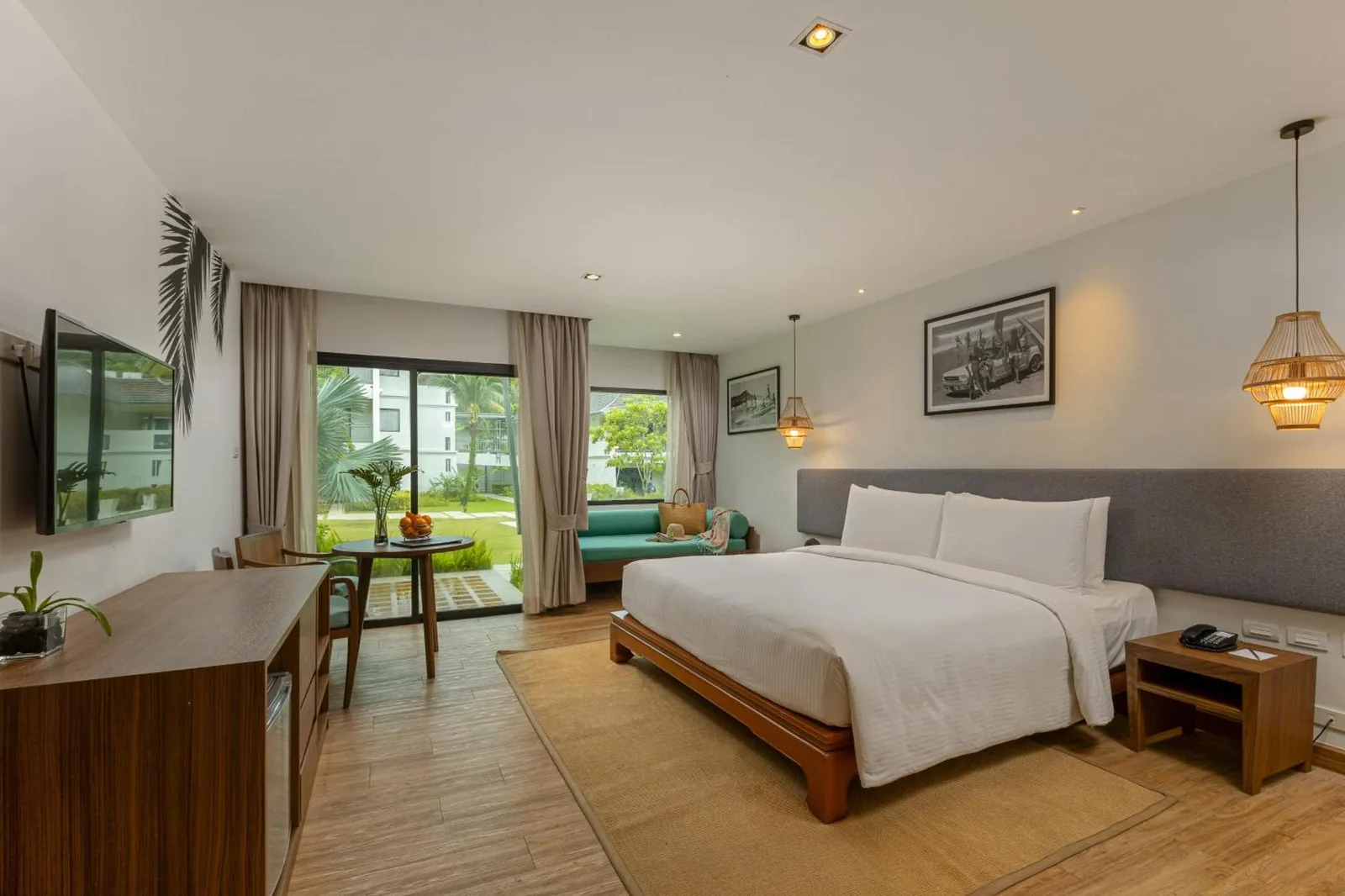 Bright resort room at OUTRIGGER Khao Lak Beach Resort in Khao Lak with sofa and garden view