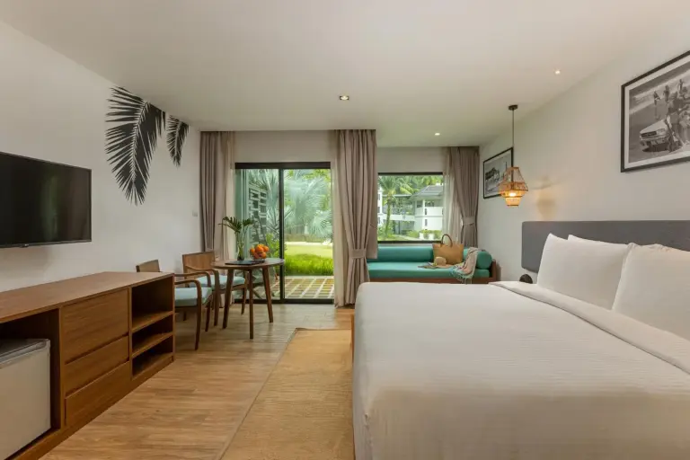 Guest room interior at OUTRIGGER Khao Lak Beach Resort in Khao Lak with garden-facing windows
