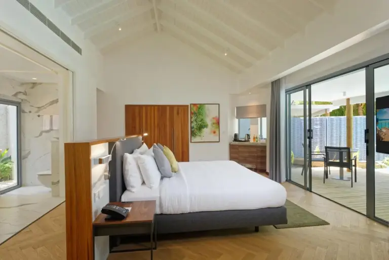 Stylish bedroom at Outrigger Maldives Maafushivaru Resort