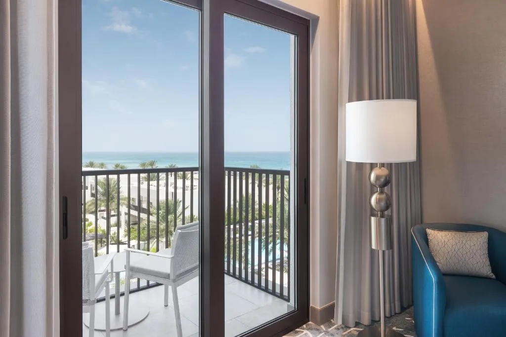 Palace Beach Resort Fujairah – Fujairah, United Arab Emirates hotel – a room with a balcony with a view of the ocean at Palace Beach Resort Fujairah in Fujairah