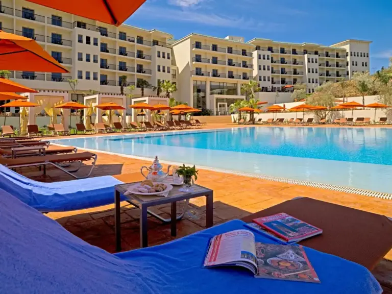 Loungers by the pool at Palais Medina Riad Resort