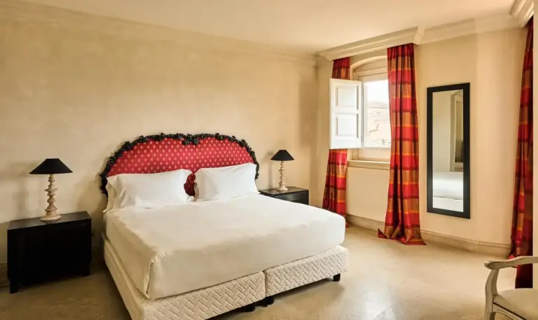 A beautifully designed double bedroom at Palazzo Gattini - The Leading Hotels of the World in Matera