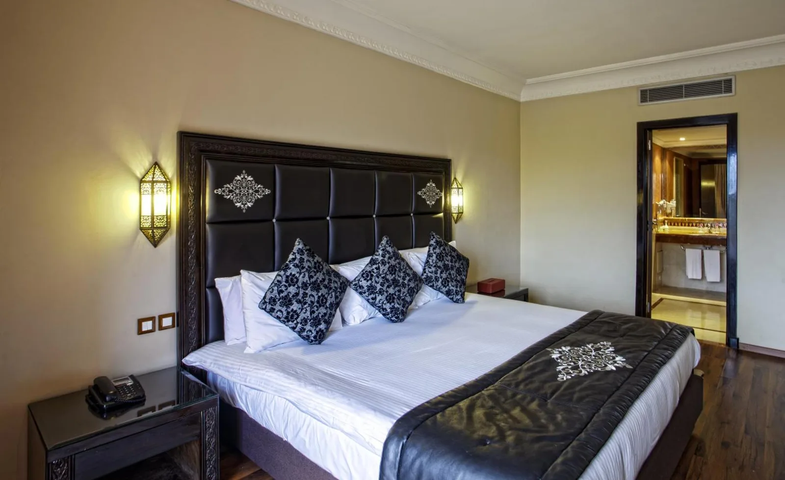 Palm Plaza Marrakech elegant room with dark furnishings