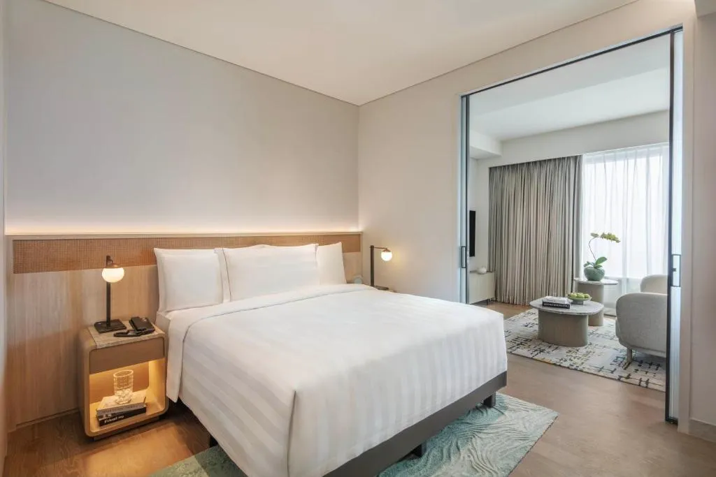 Elegant bedroom with separate living space at PARKROYAL Serviced Suites Jakarta