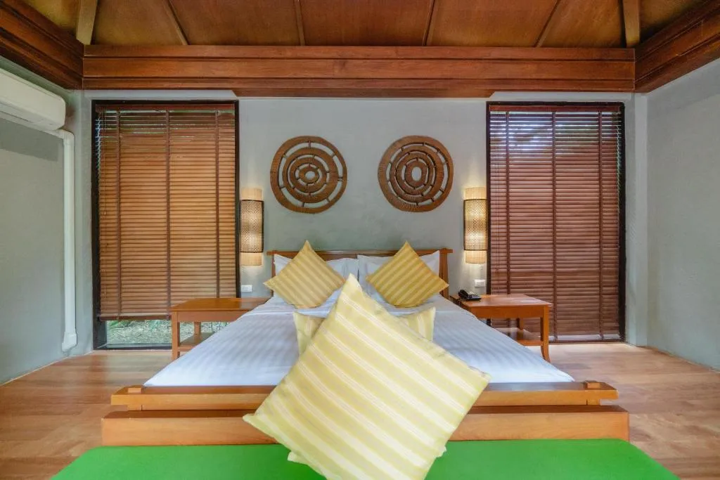 Inviting bed with decor at Pattara Resort & Spa