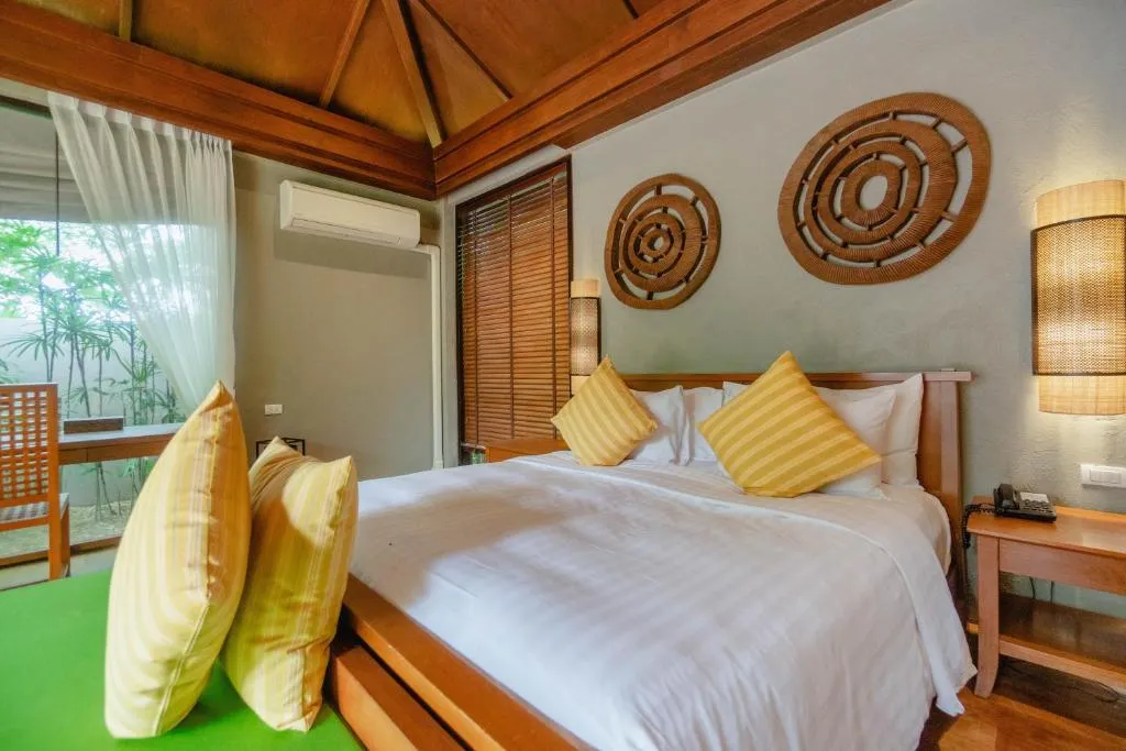 Cozy bed in the guest room at Pattara Resort & Spa