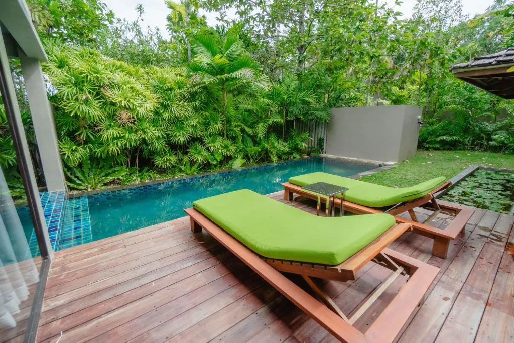Lounge chairs by the pool at Pattara Resort & Spa