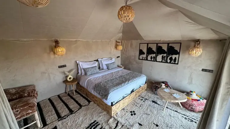 Luxury tent bedroom at Peaceful Luxury Camp in Merzouga