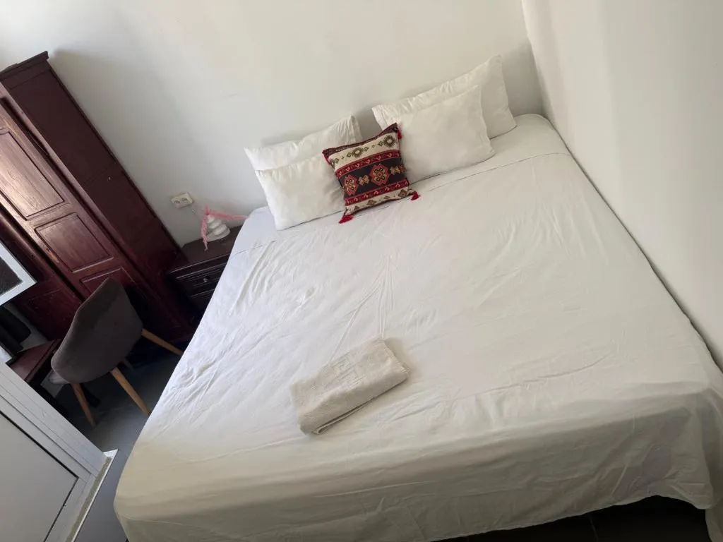 Queen bed in a room at Pension Gibraltar, Tangier