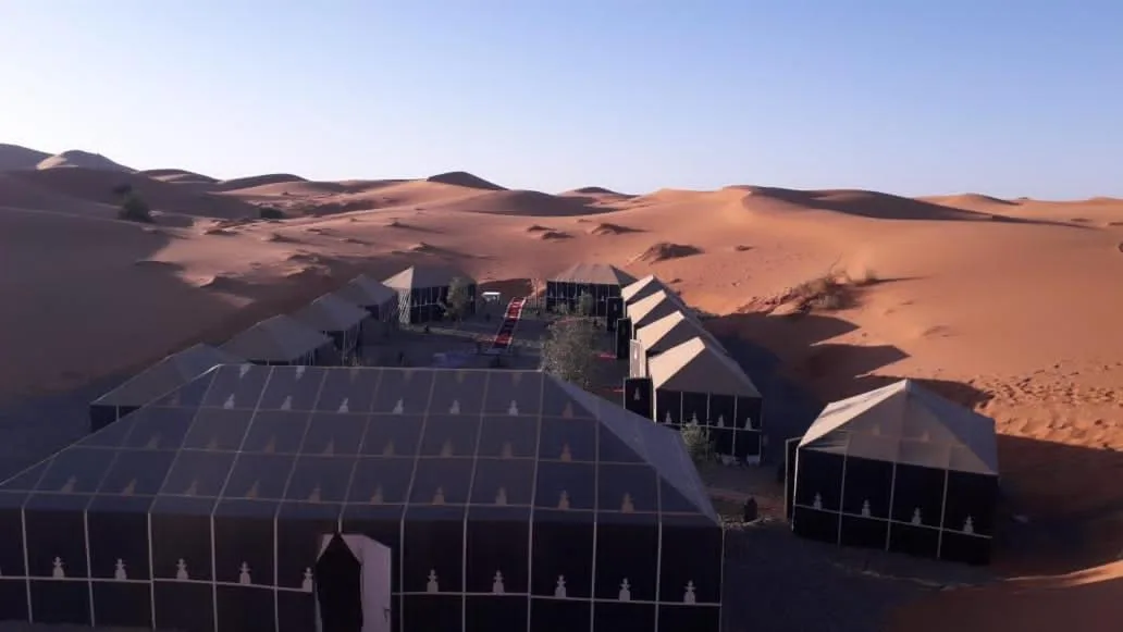 Aerial view of Planet Sahara Camp in Merzouga with tented accommodations in the desert