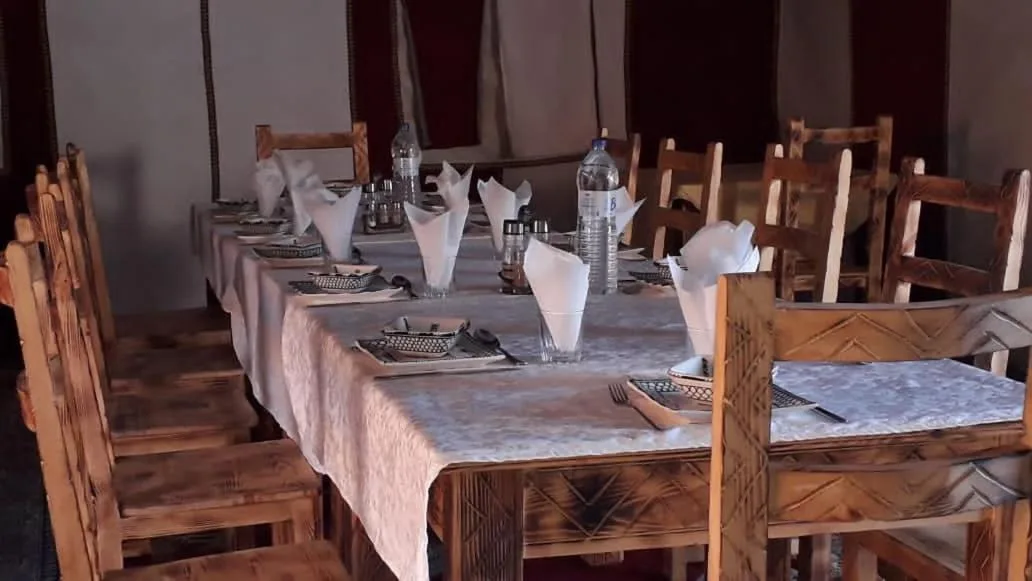 Dining table setup inside Planet Sahara Camp in Merzouga
