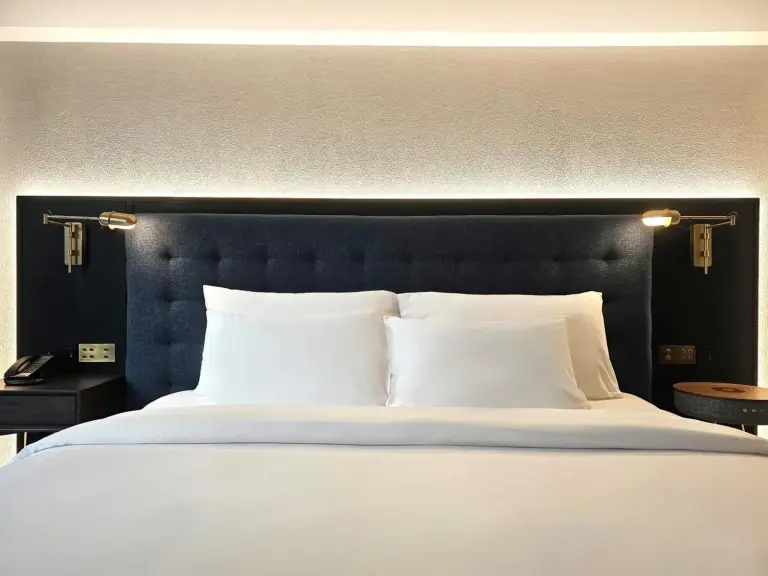 Elegant bedding in a room at Public House Bangkok