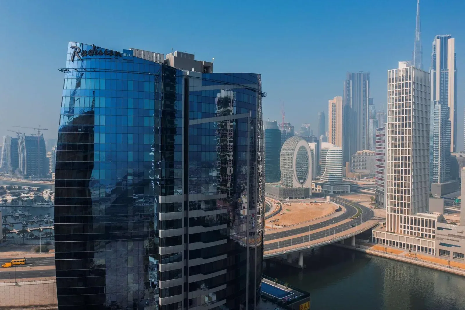 Exterior view of Radisson Blu Hotel, Dubai Canal View in Dubai with the city skyline and canal visible