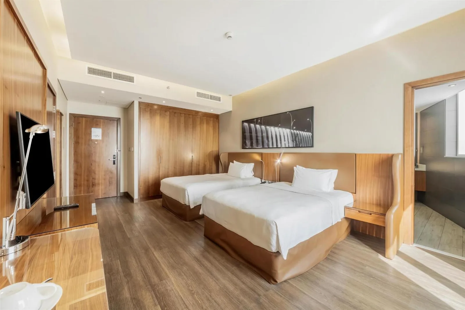 Twin bedroom at Radisson Blu Hotel, Dubai Canal View with two single beds and a window view