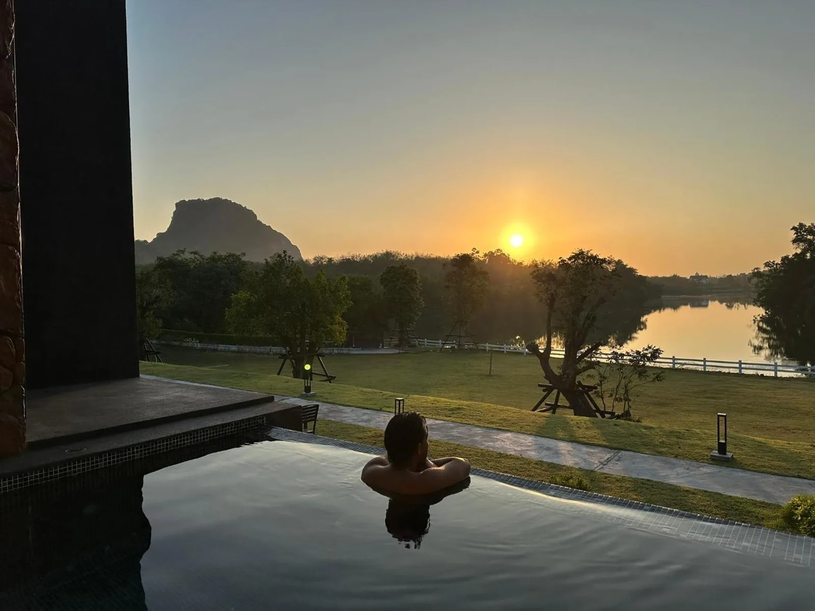Guest relaxing in the pool at sunset at Ramrom Valley Resort - รามโรมวัลเลย์รีสอร์ท นครศรีธรรมราช