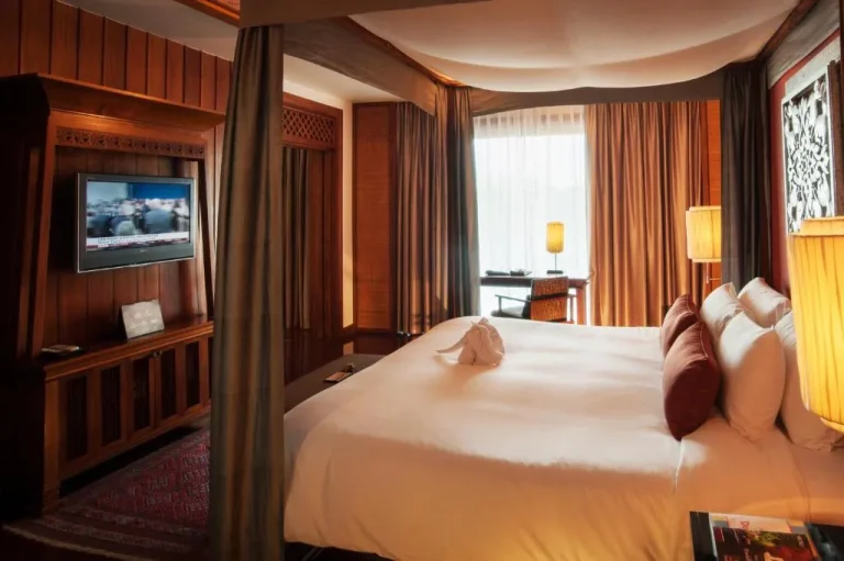 Comfortable bedroom with amenities at RatiLanna Riverside Spa Resort