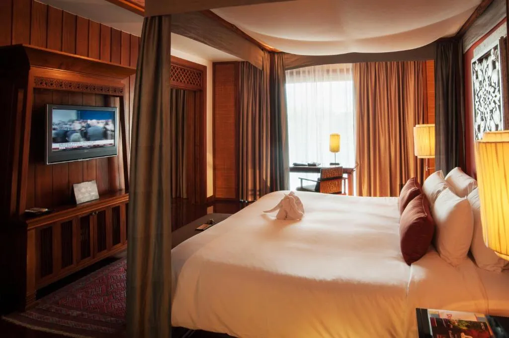 Comfortable bedroom with amenities at RatiLanna Riverside Spa Resort