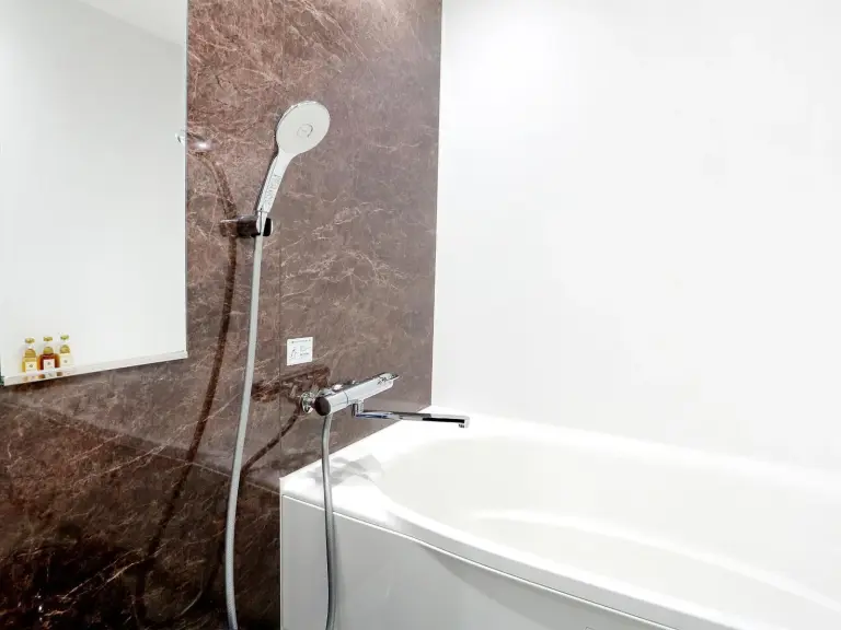 Bright bathroom at RE Hotel Umeda-2 in Osaka with vessel sink and toilet.